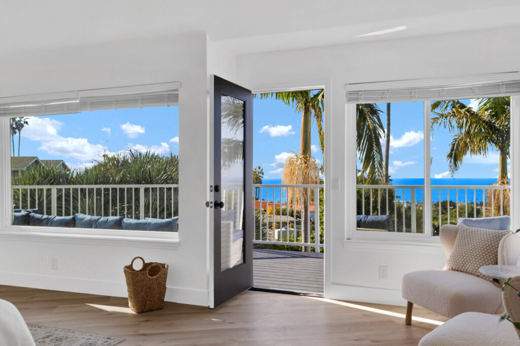 Bedroom sitting area opening onto a balcony with ocean views at Oceans Luxury Rehab