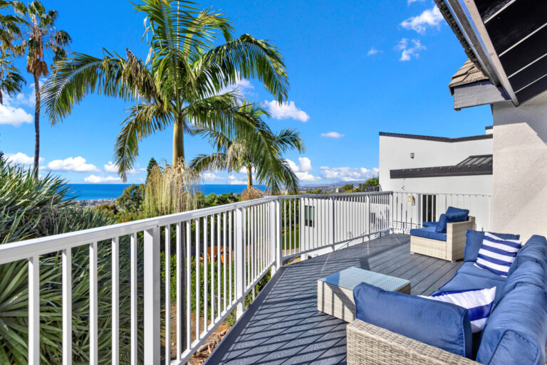 Ocean-view deck with lounge seating and palm trees at Oceans Luxury Rehab in San Clemente