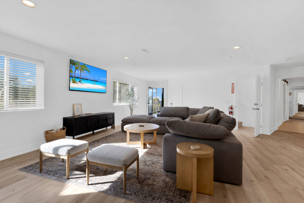 Bright living room with sectional sofa at Oceans Luxury Rehab in San Clemente