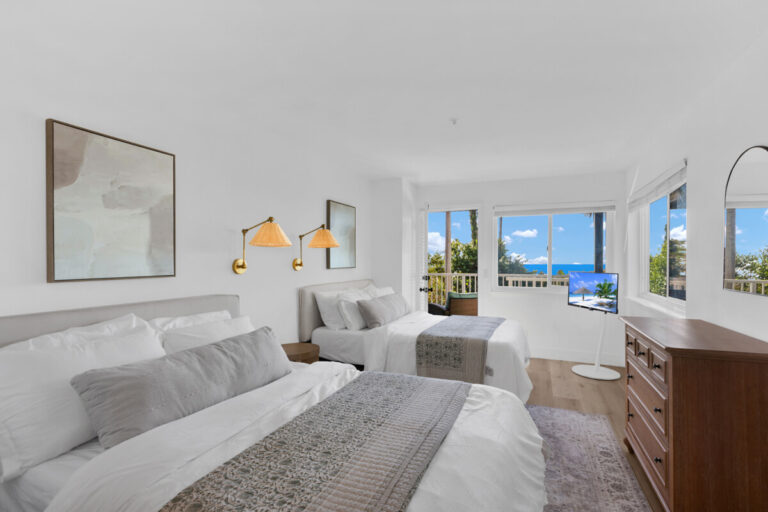 Private bedroom with ocean-view windows at Oceans Luxury Rehab in San Clemente