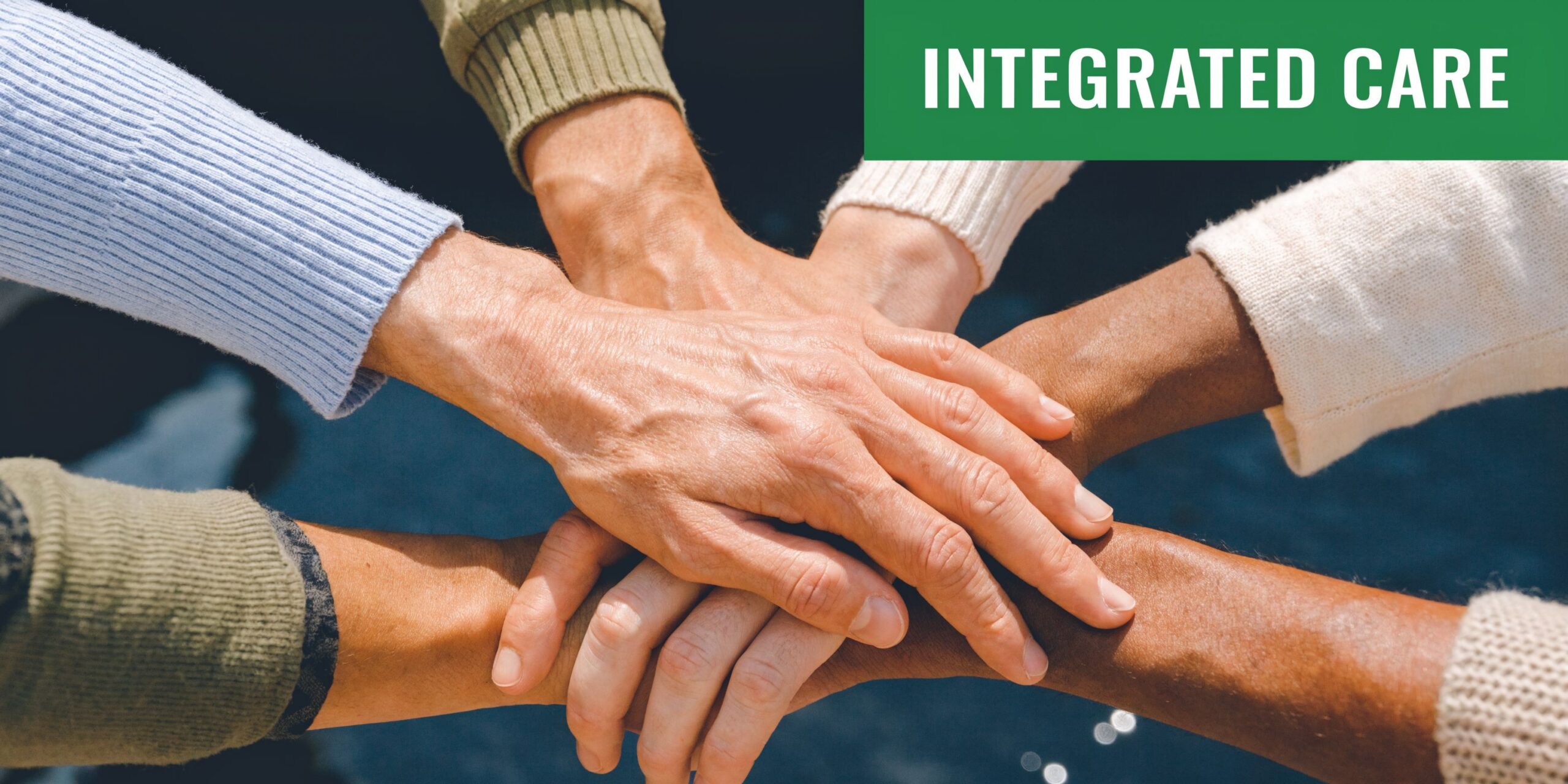 Multiple hands of diverse people stacked together in a circle symbolizing unity and integrated health care support.