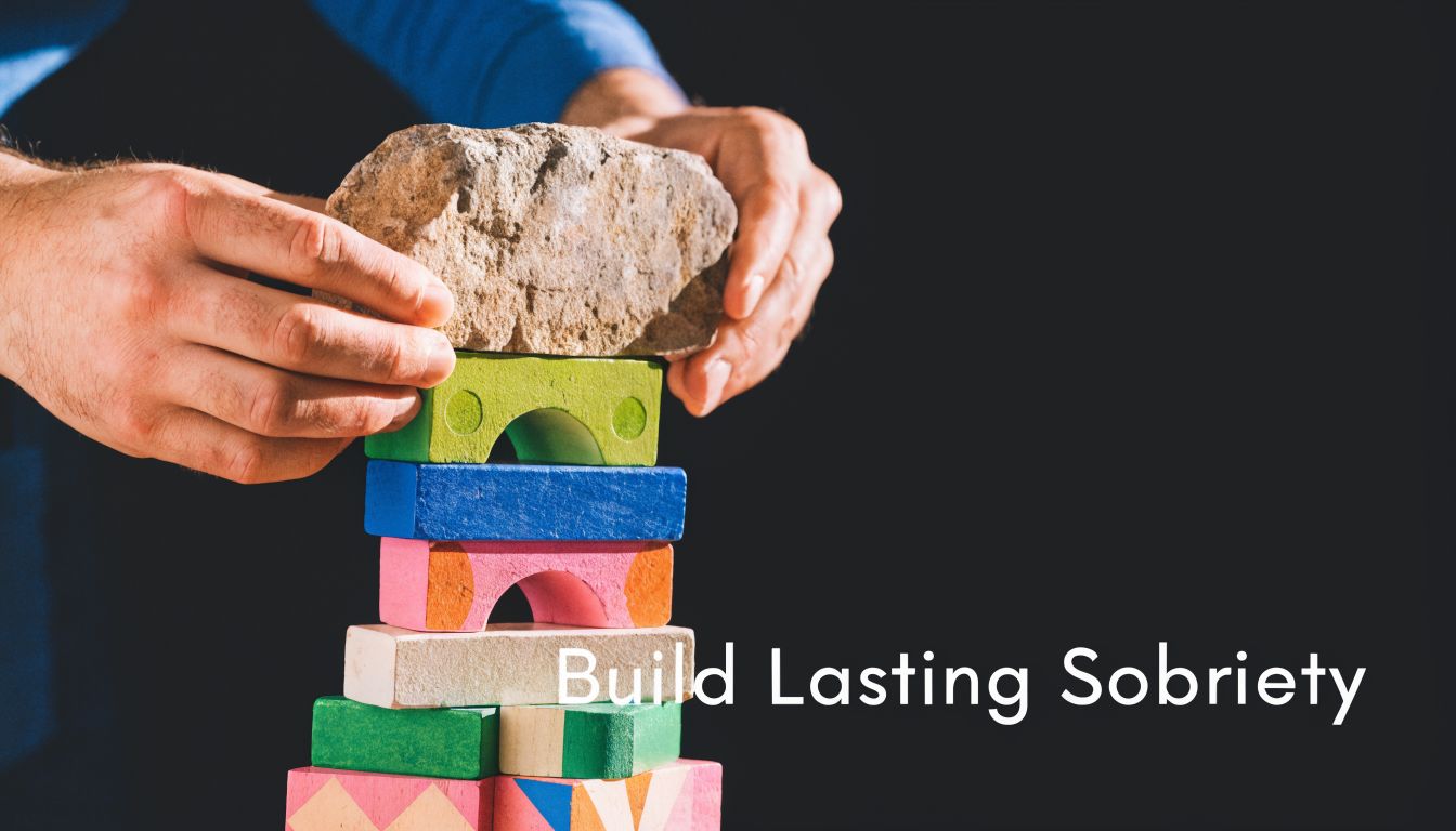 A person placing a heavy stone on top of a stack of colorful building blocks.