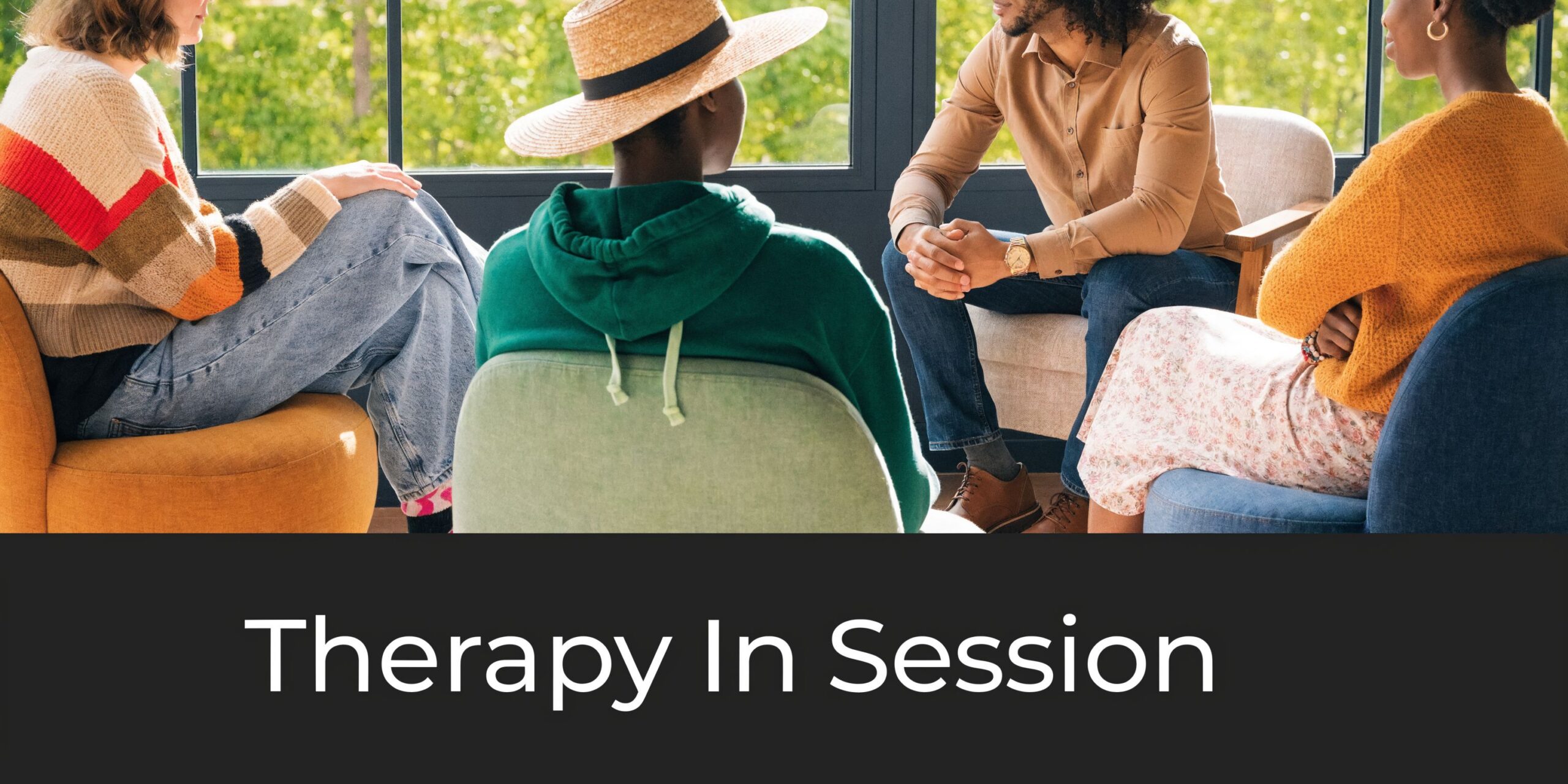 A diverse group of people sitting in a circle during a guided therapy session indoors.