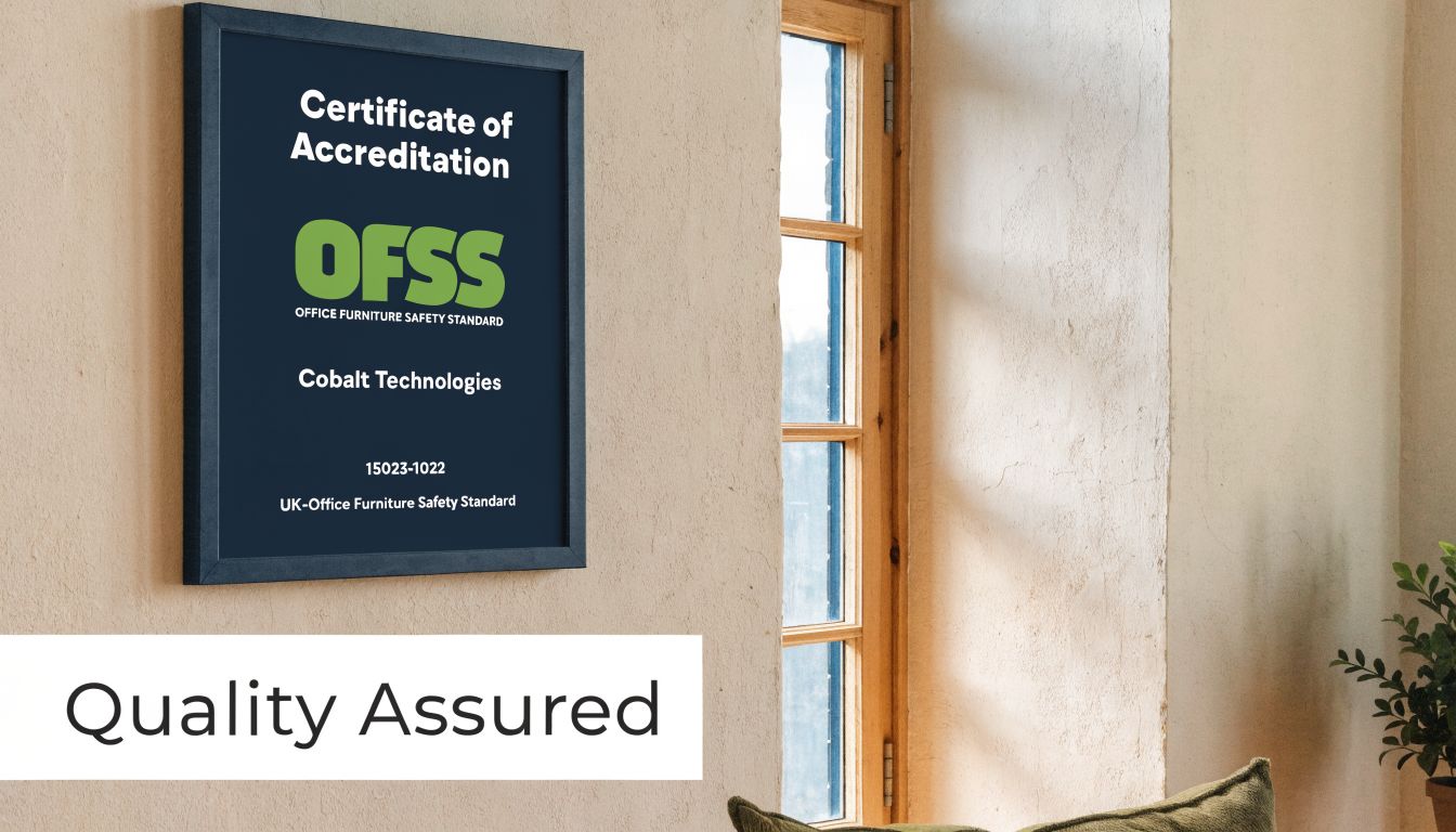 A framed Certificate of Accreditation for office furniture safety hanging on a beige wall indoors.
